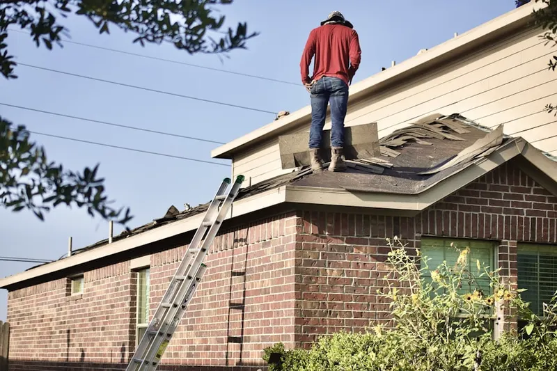 Professional roofer working on a residential roof in Corning